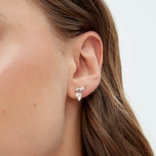 Close-up of 18K Solid Gold Bow & Plume Floating Lab Diamond Stud Earring, highlighting extremely shiny gold finish and floating diamond detail.