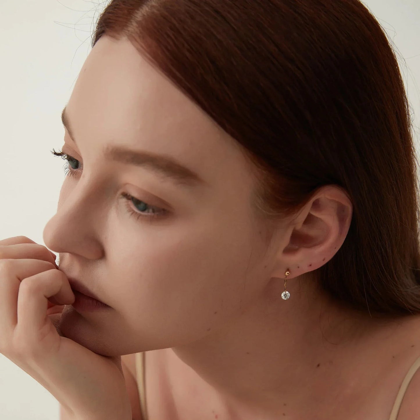 Side view showing the secure 18K gold threaded screw back design