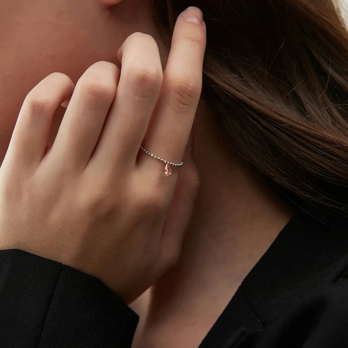 Side profile of the Radiant Drift chain ring showing the 360-degree exposure of the pink pear diamond. The laser-drilled 18K solid gold construction eliminates settings, revealing the diamond's geometric depth and structural rhythm. A masterclass in minimalist, setting-free jewelry design.