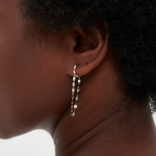 An extreme close-up macro view of the Marquise and Chain Dangle Hoop, highlighting the exceptional VVS-VS clarity and D-E color of the eight premium white lab-grown diamonds. The image details the meticulous 18K solid gold setting of the five hoop stones and the delicate links of the diamond chain holding three floating marquise gems. This shot emphasizes the superior artisanal quality and rhythmic sparkle of the white diamonds, perfect for collectors of high-fashion fine jewelry.