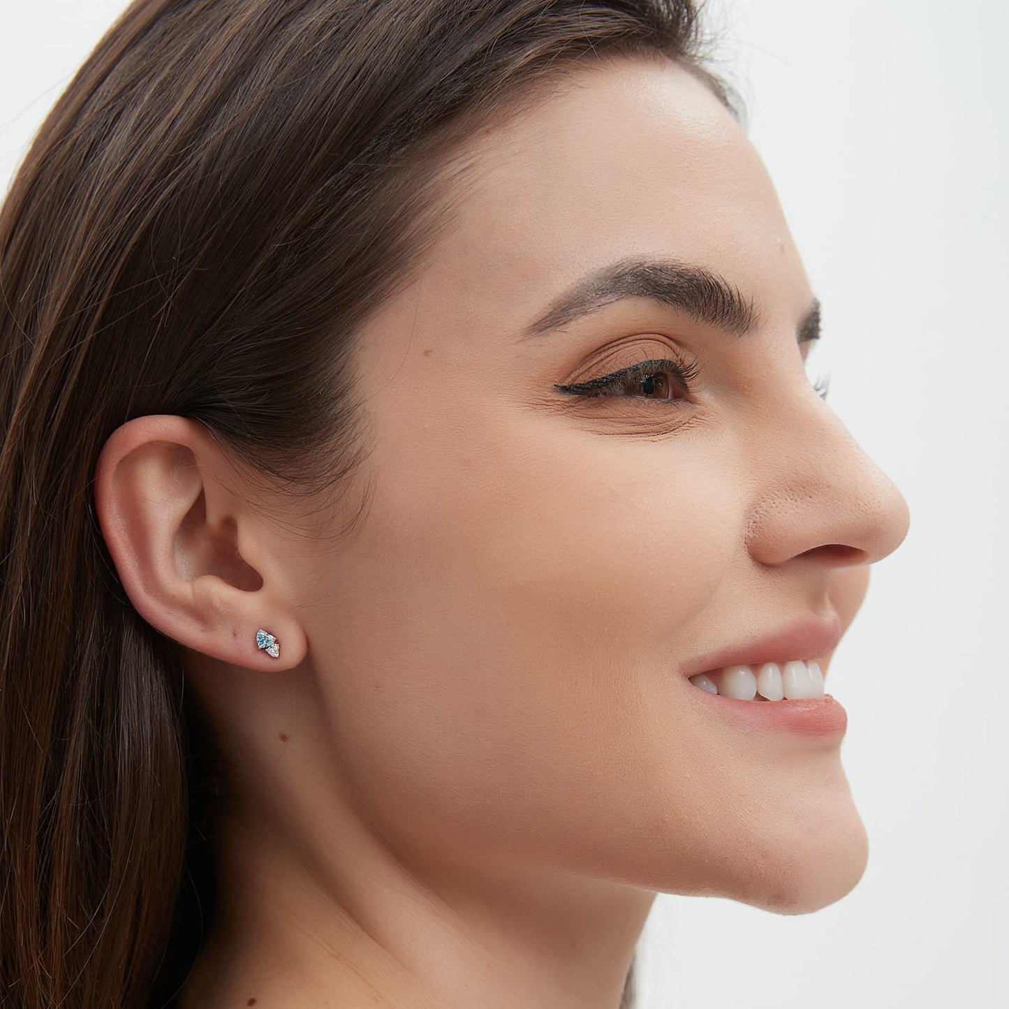 Model wearing the Eternal Heart blue and white heart diamond stud on the ear lobe