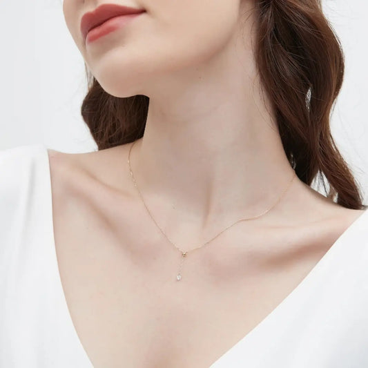 A detailed macro close-up focusing on the 0.2ct round brilliant diamond and the adjustable sliding bead mechanism of the Radiant Drift Necklace. The high-definition image reveals the exceptional fire and crystalline fire of the D-E color diamond and the precision of the 18K solid gold settings. The close-up emphasizes the innovative functional design that allows the stone to glide effortlessly along the chain, showcasing the master craftsmanship and architectural quality of LTM Jewels.