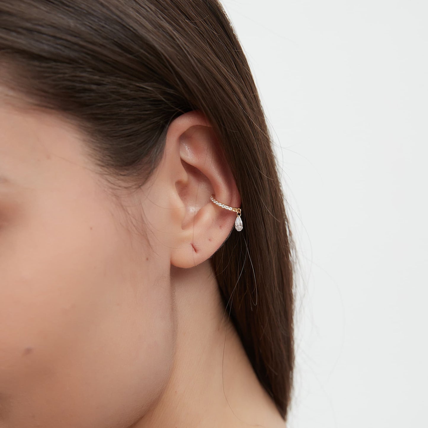 Side view of the pear diamond dangle cuff showing the secure non-pierced fit