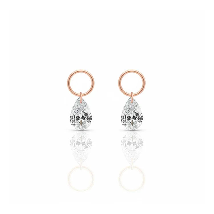 A single pear-cut lab-grown diamond charm for earrings, expertly laser-drilled for a unique floating effect in 18K solid gold. This minimalist jewelry piece by LTM Jewels showcases the brilliance of a VVS-VS clarity, D-E color diamond without a traditional setting. Perfect as a modular jewelry accessory for curated ear stacks, this 18K gold diamond dangle charm offers a weightless, sophisticated aesthetic for modern luxury lovers seeking ethical, sustainable fine jewelry.