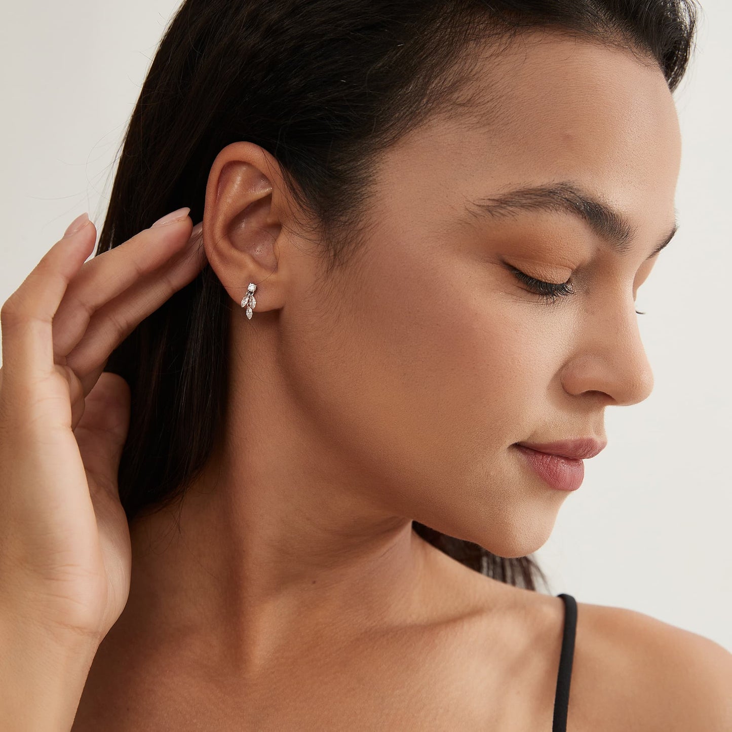 Side profile showing the dangle structure and secure 18K gold threaded back.