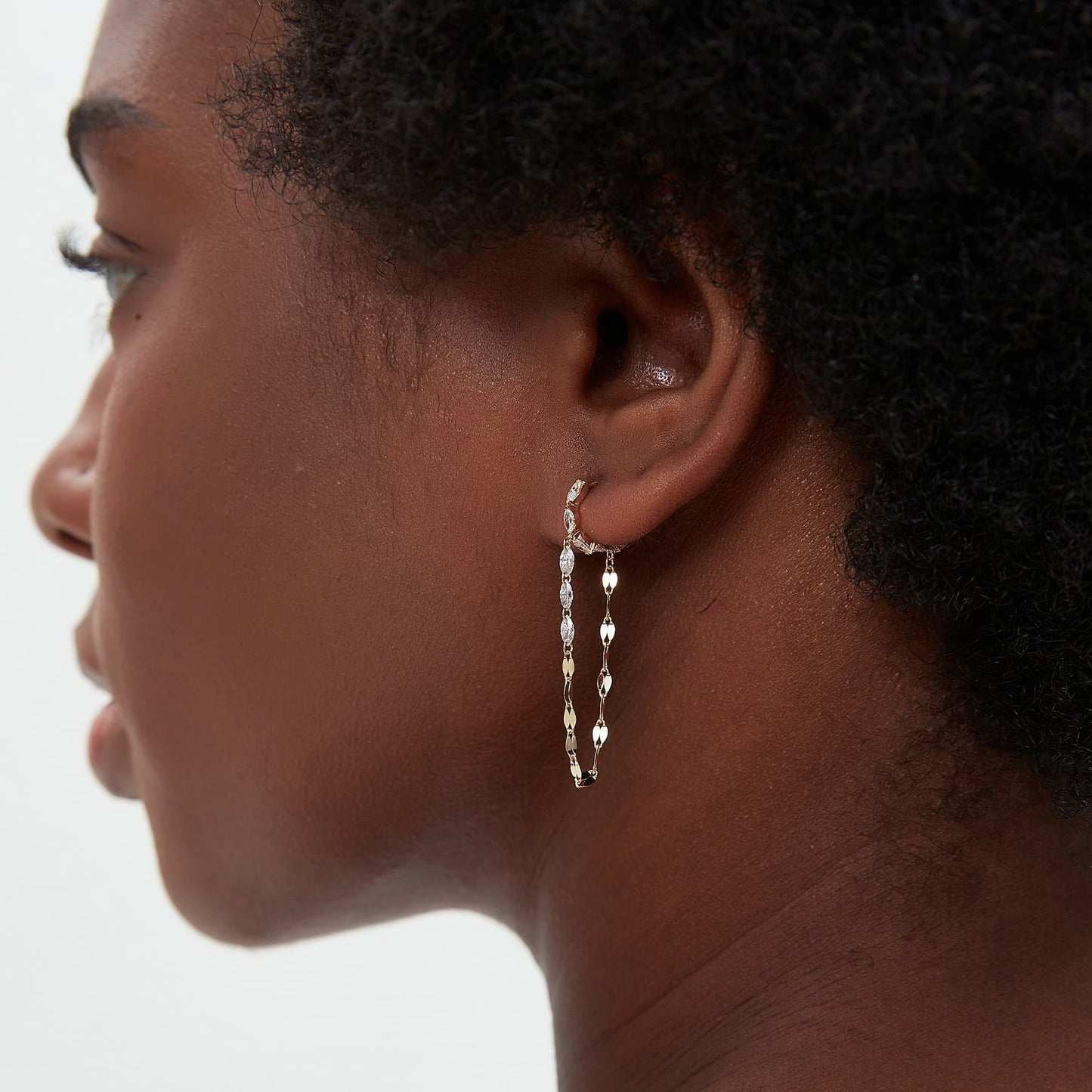 Detailed side profile of the Marquise and Chain Dangle Hoop, showcasing the 7mm inner diameter and the secure, seamless clicker hinge mechanism crafted in 18K solid gold. The image highlights the sturdy gold construction and the hypoallergenic properties of the Au750 metal, ensuring a flush and comfortable permanent fit for 24/7 wear. The profile view illustrates how the diamond chain hangs gracefully from the marquise-set hoop, maintaining a balanced and fluid silhouette.