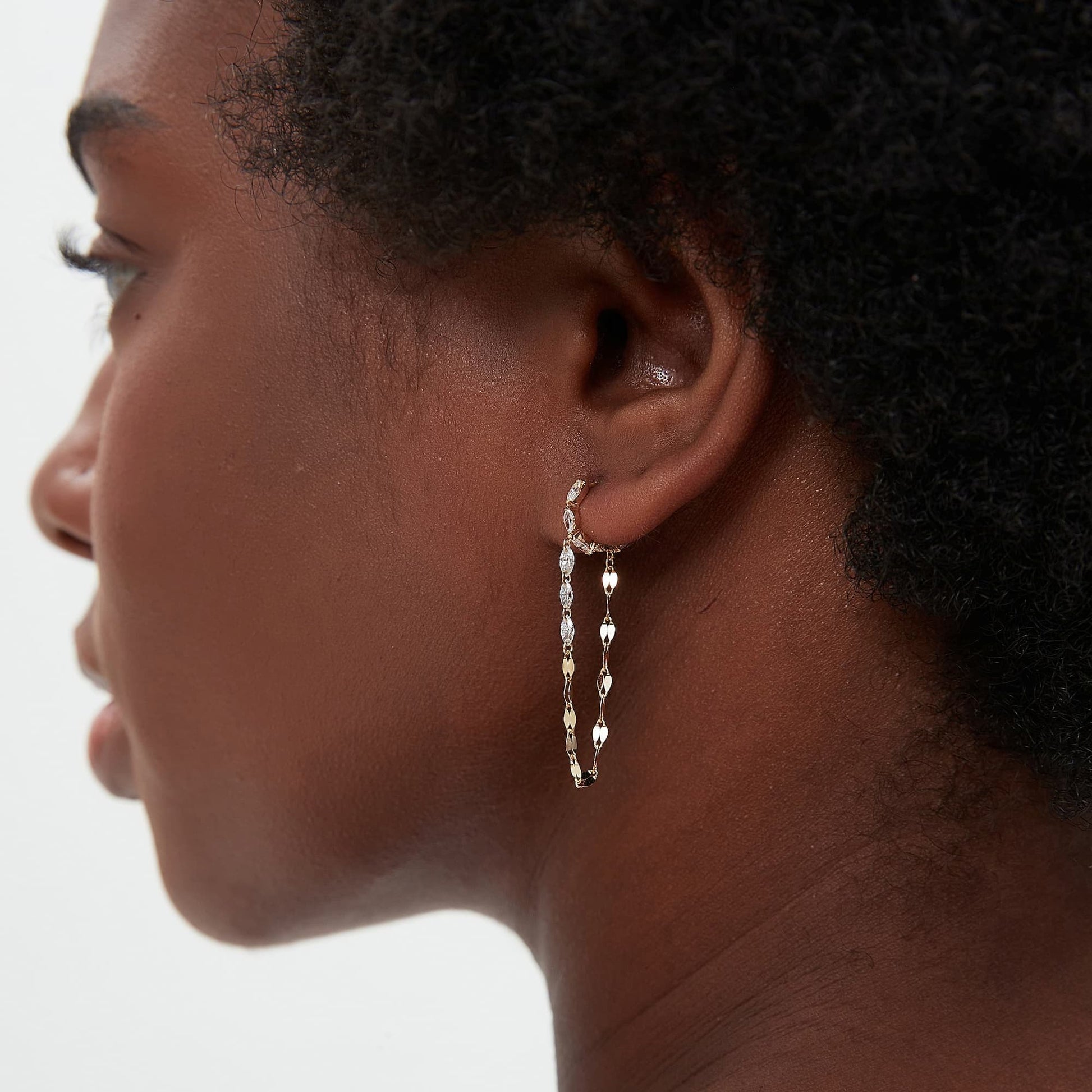Detailed side profile of the Marquise and Chain Dangle Hoop, showcasing the 7mm inner diameter and the secure, seamless clicker hinge mechanism crafted in 18K solid gold. The image highlights the sturdy gold construction and the hypoallergenic properties of the Au750 metal, ensuring a flush and comfortable permanent fit for 24/7 wear. The profile view illustrates how the diamond chain hangs gracefully from the marquise-set hoop, maintaining a balanced and fluid silhouette.