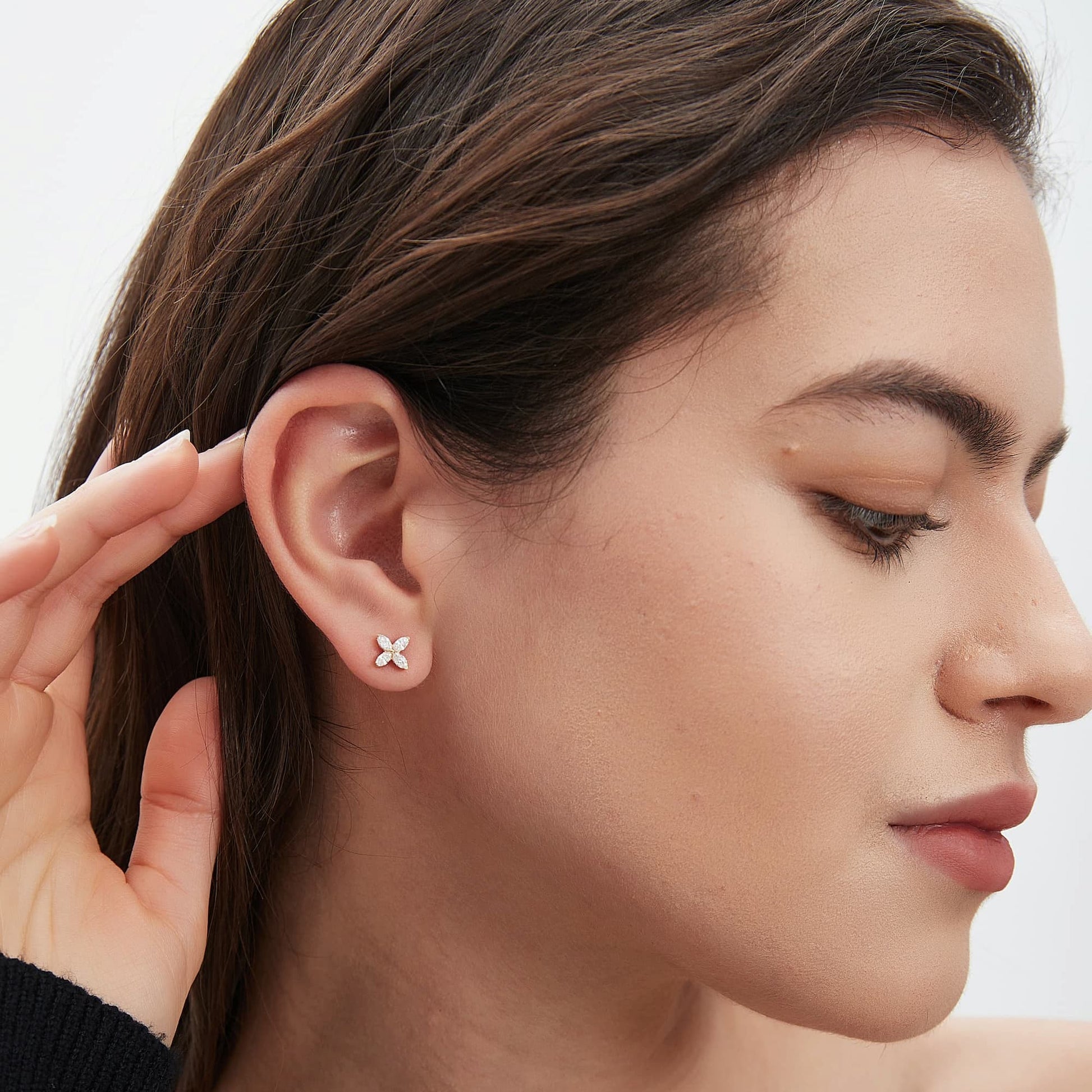 Back view of clover diamond stud earrings in 18K white gold showing the earring post and secure butterfly back.