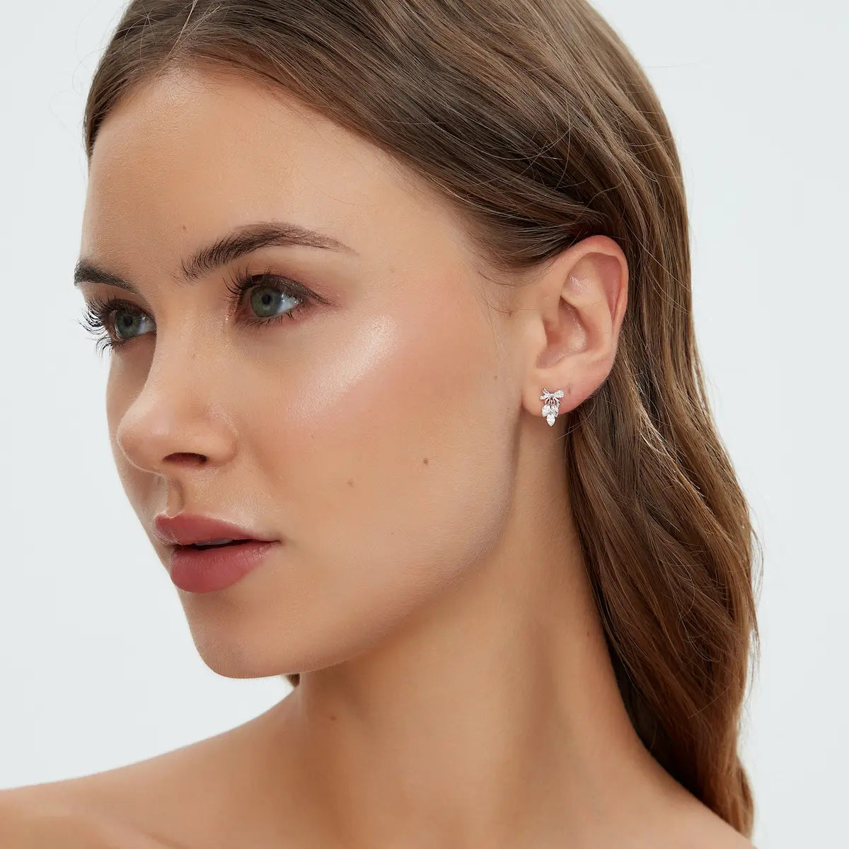 18K Solid Gold Bow & Plume Floating Lab Diamond Stud Earring worn on ear, showcasing shiny gold structure and floating diamond effect for everyday luxury wear.