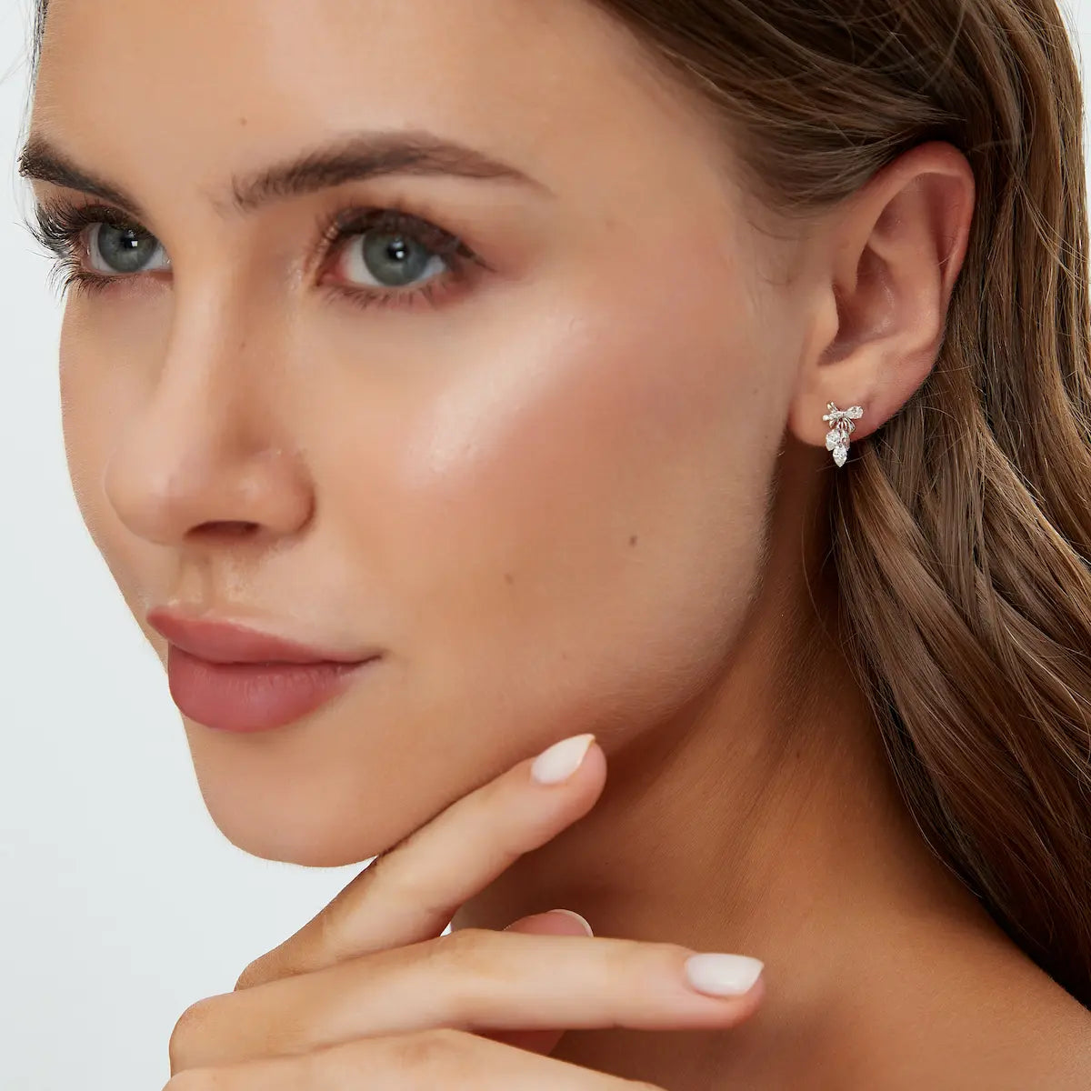 Model wearing 18K Solid Gold Bow & Plume Floating Lab Diamond Stud Earrings by LTM & CO.™, styled as elegant modern fine jewelry with sculptural shine.