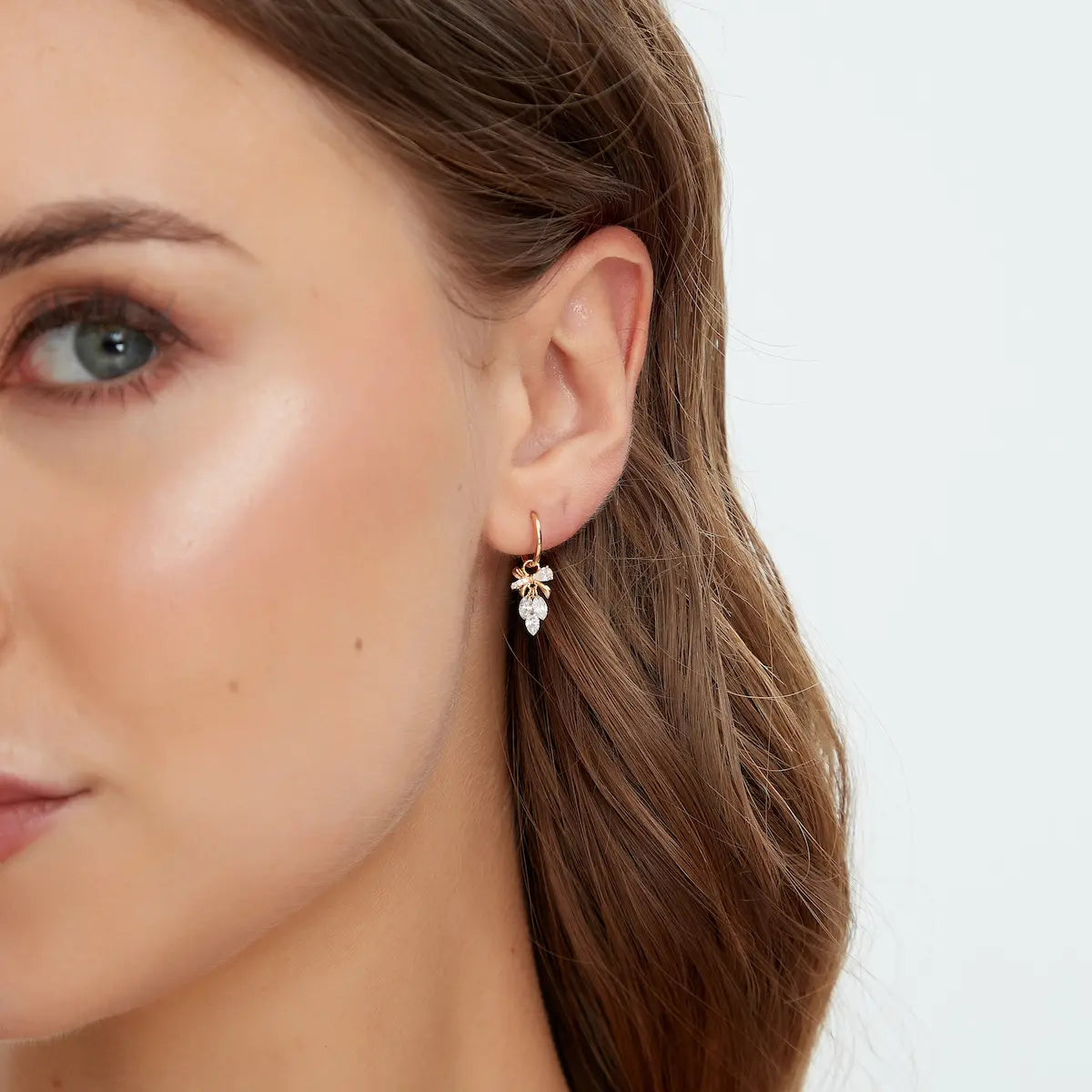 18K Solid Gold Bow & Plume Floating Lab Diamond Charm styled on hoop earring, showing floating diamond effect, hoop not included.