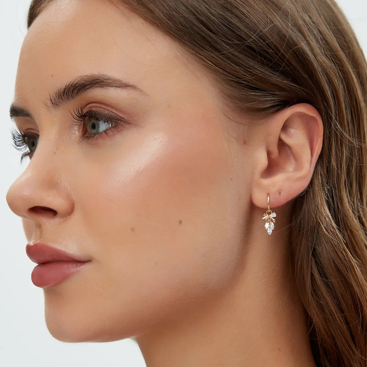 Model wearing 18K Solid Gold Bow & Plume Floating Lab Diamond Charm by LTM & CO.™, styled with hoop earring, charm only.