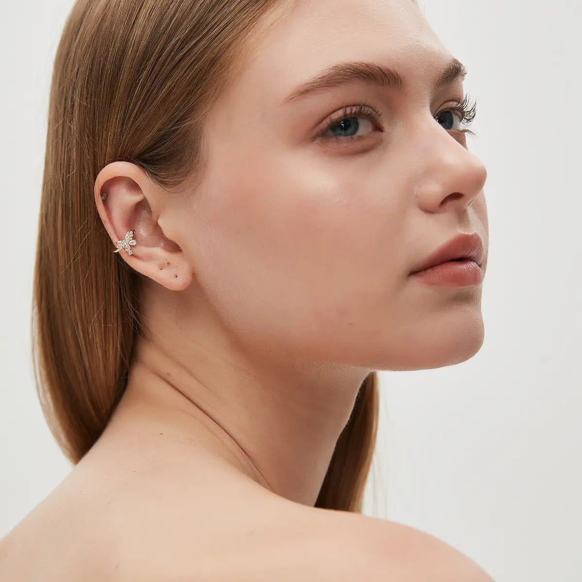 Butterfly Diamond Ear Cuff shown worn on the ear without a piercing, featuring an 18K solid gold butterfly-inspired design accented with 0.40ct total lab-grown white diamonds. The elegant silhouette adds a refined touch of sparkle and can be styled with other earrings for a curated ear.