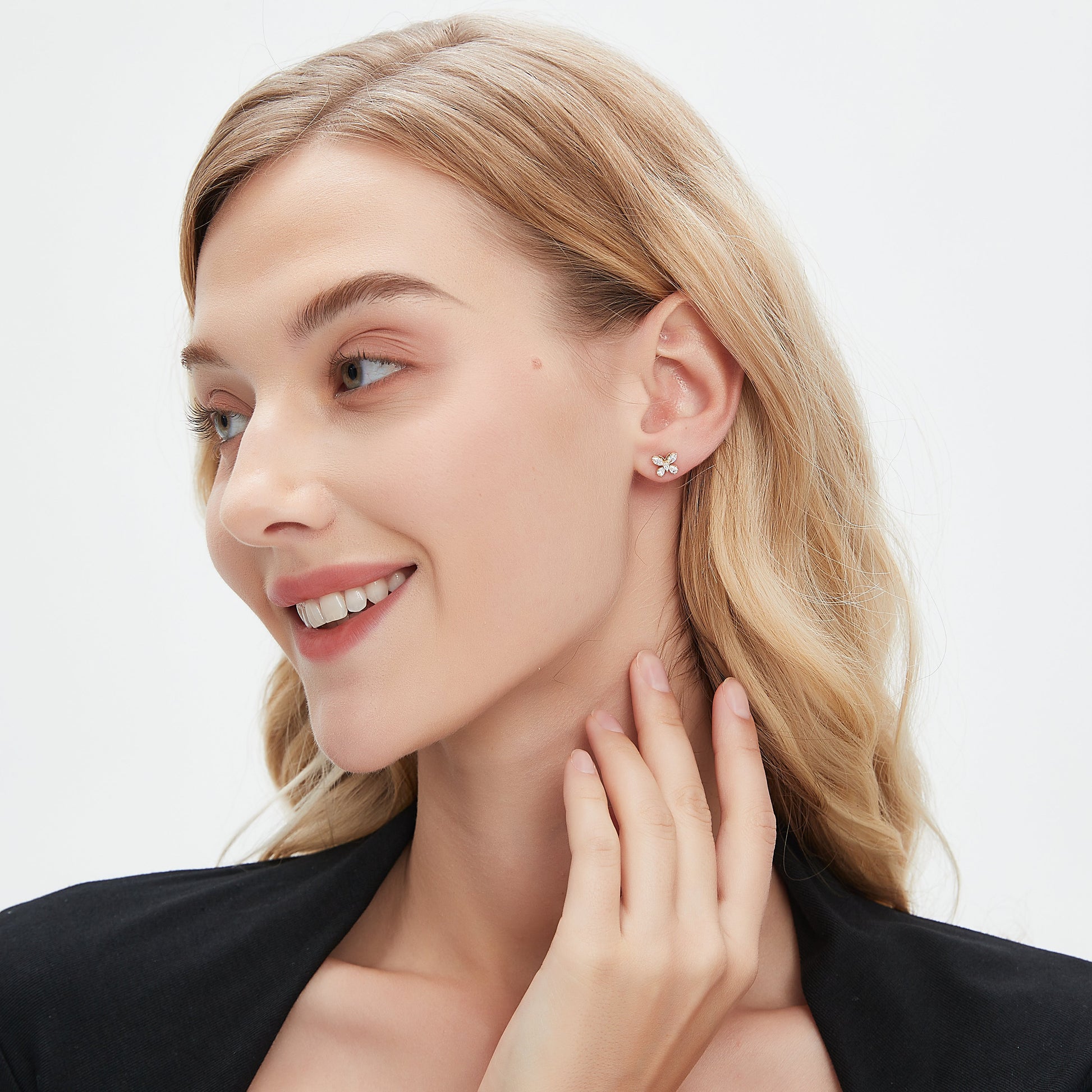 Woman wearing a diamond earring on a white background