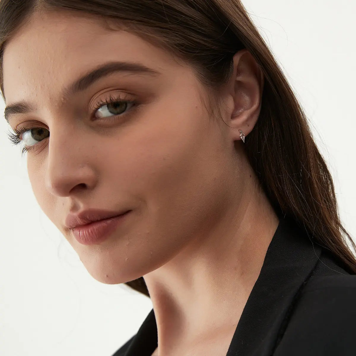 Model wearing the Kite Threaded Dangle Stud from the Architectural Rhythm collection. The floating geometric kite-cut diamond and sculptural gold silhouette create cinematic brilliance, architectural elegance, and contemporary editorial luxury jewelry styling.
