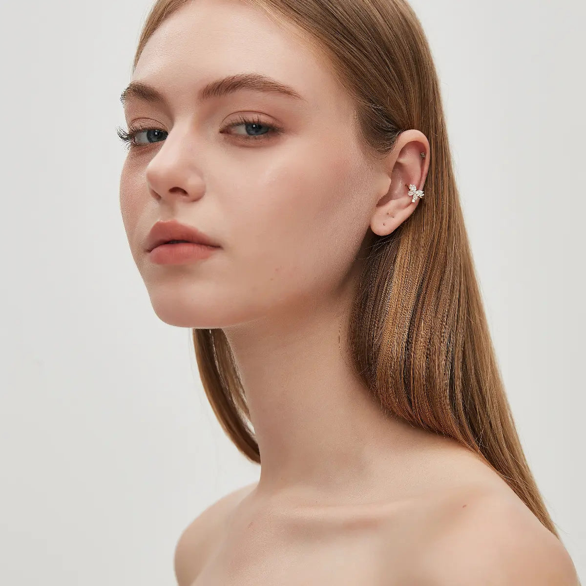 Model wearing the LTM & CO. Butterfly Diamond Ear Cuff from the Celestial Drift collection, crafted in 18K solid gold and accented with 0.40ct total lab-grown white diamonds. The no-piercing design adds a graceful touch of diamond brilliance to a modern and elegant jewelry look.