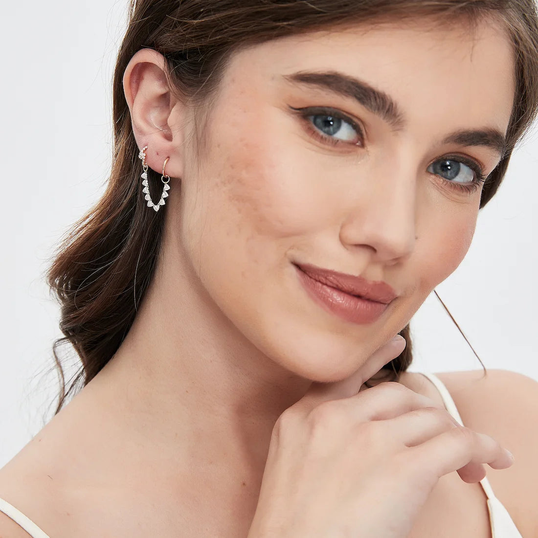 Model wearing the 18K gold floating heart diamond connecting charm from LTM Jewels’ Celestial Drift collection. The delicate suspended heart-cut lab diamond creates a luminous romantic silhouette with modern minimalist elegance designed for elevated everyday fine jewelry styling and layered luxury looks.
