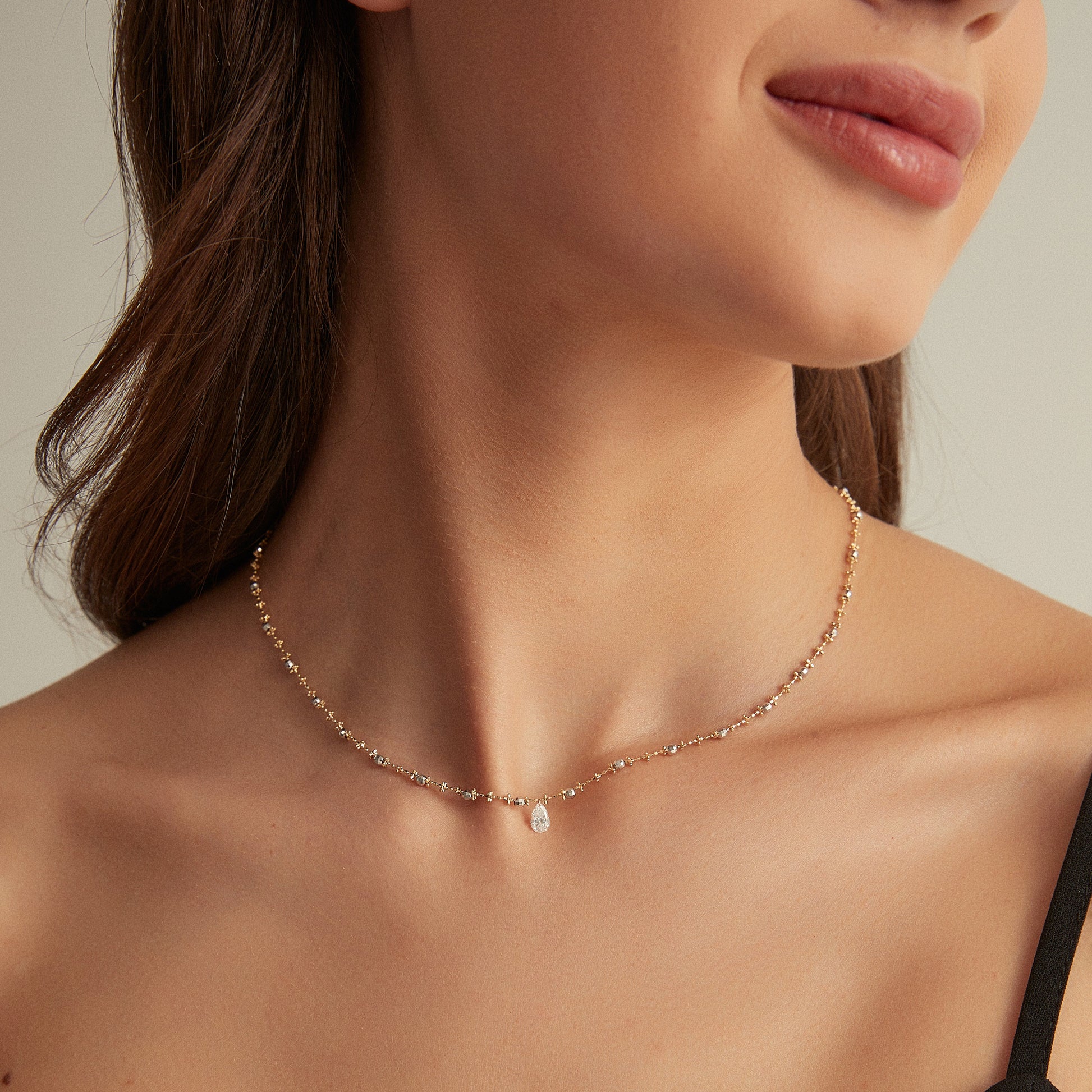 Necklace worn by a person with a neutral background