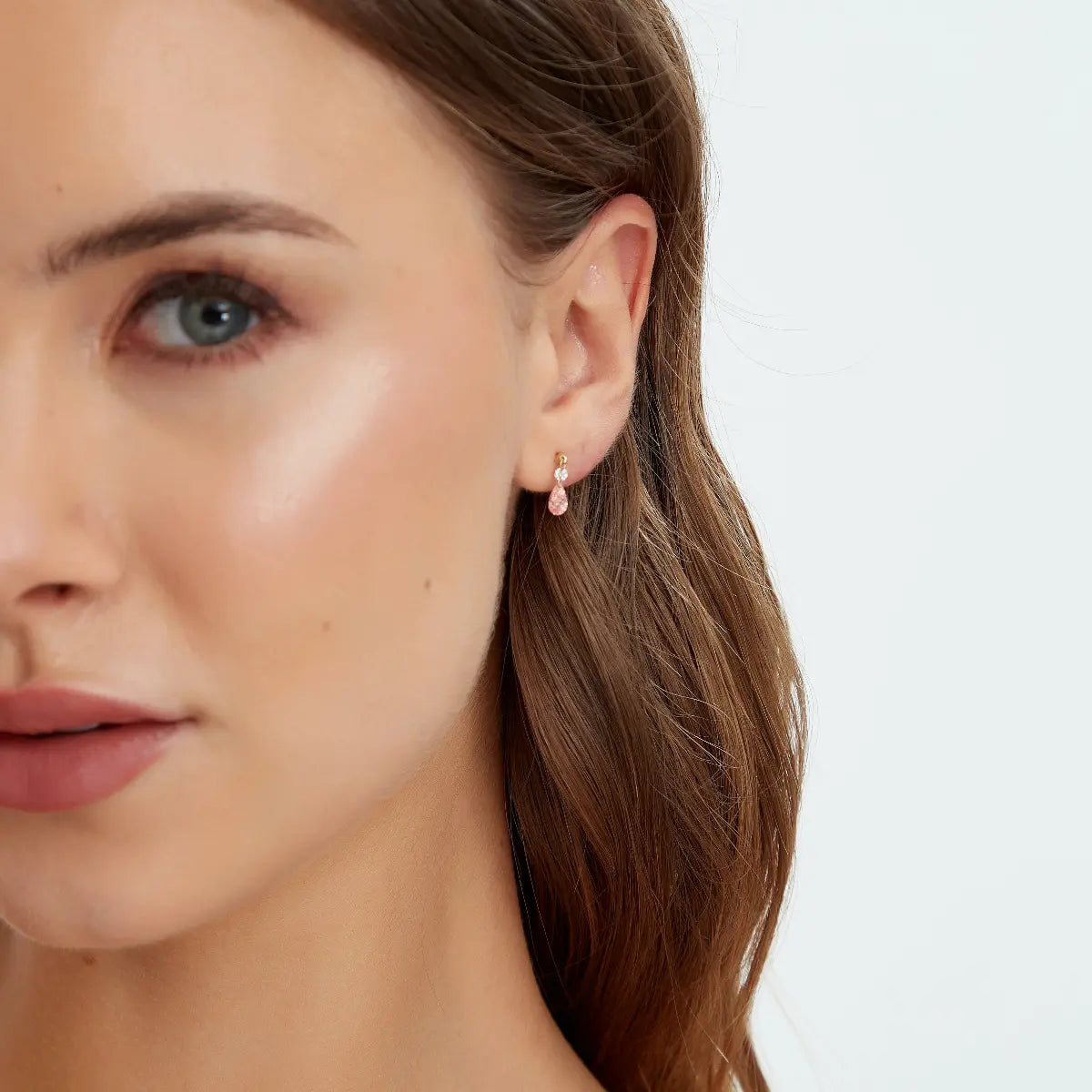 Side view of Pink Pear and Round Floating Lab Diamond Stud in 18K gold, showing the floating structure with pink pear and round white diamond