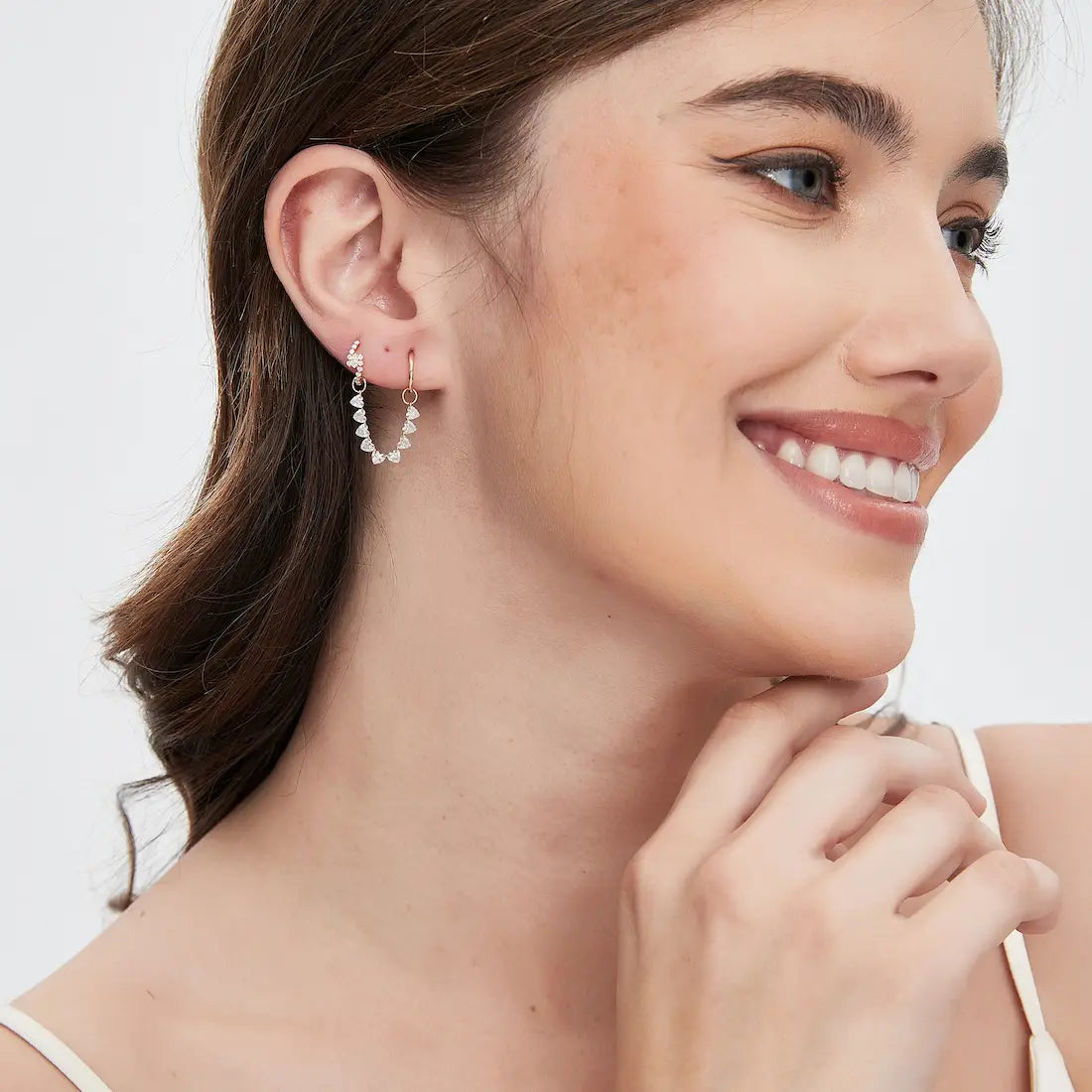 Side view of the 18K gold floating heart diamond connecting charm showcasing the clean polished gold structure and precision floating diamond construction. The lightweight modular design is engineered for seamless pairing with hoops and studs while maintaining comfort, movement, and refined luxury craftsmanship.