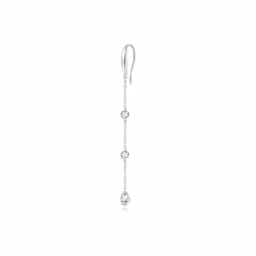 A high-resolution photo of the Triple Diamond Chain Dangle Hoop from LTM Jewels. Showcases 0.40ctw of round and pear diamonds on an 18K solid gold chain, emphasizing its vertical raindrop effect and cinematic sparkle.