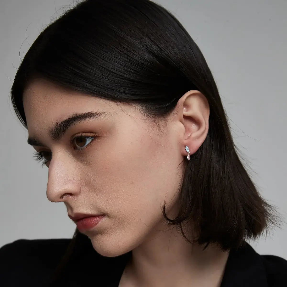 Side view of the Blue and Pink Marquise Dangle Stud crafted in solid 18K gold showcasing the secure threaded screw-back structure and suspended floating diamond construction. The lightweight sculptural design is engineered for comfortable 24/7 wear and refined contemporary styling.