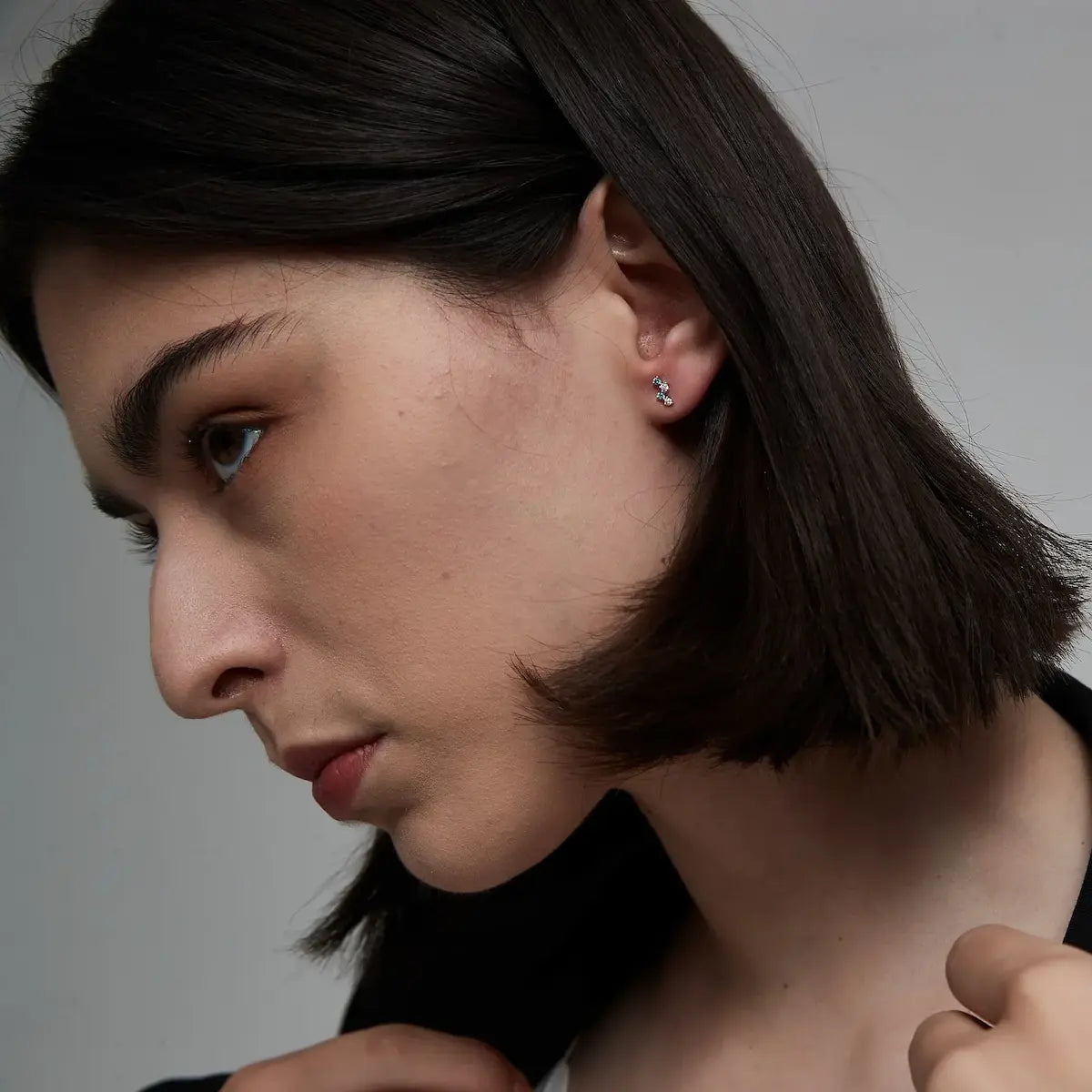 Model wearing Round Floating Blue & White Lab Diamond Threaded Stud Earrings in 18K solid gold by LTM & CO.™, styled with a soft floating diamond effect.