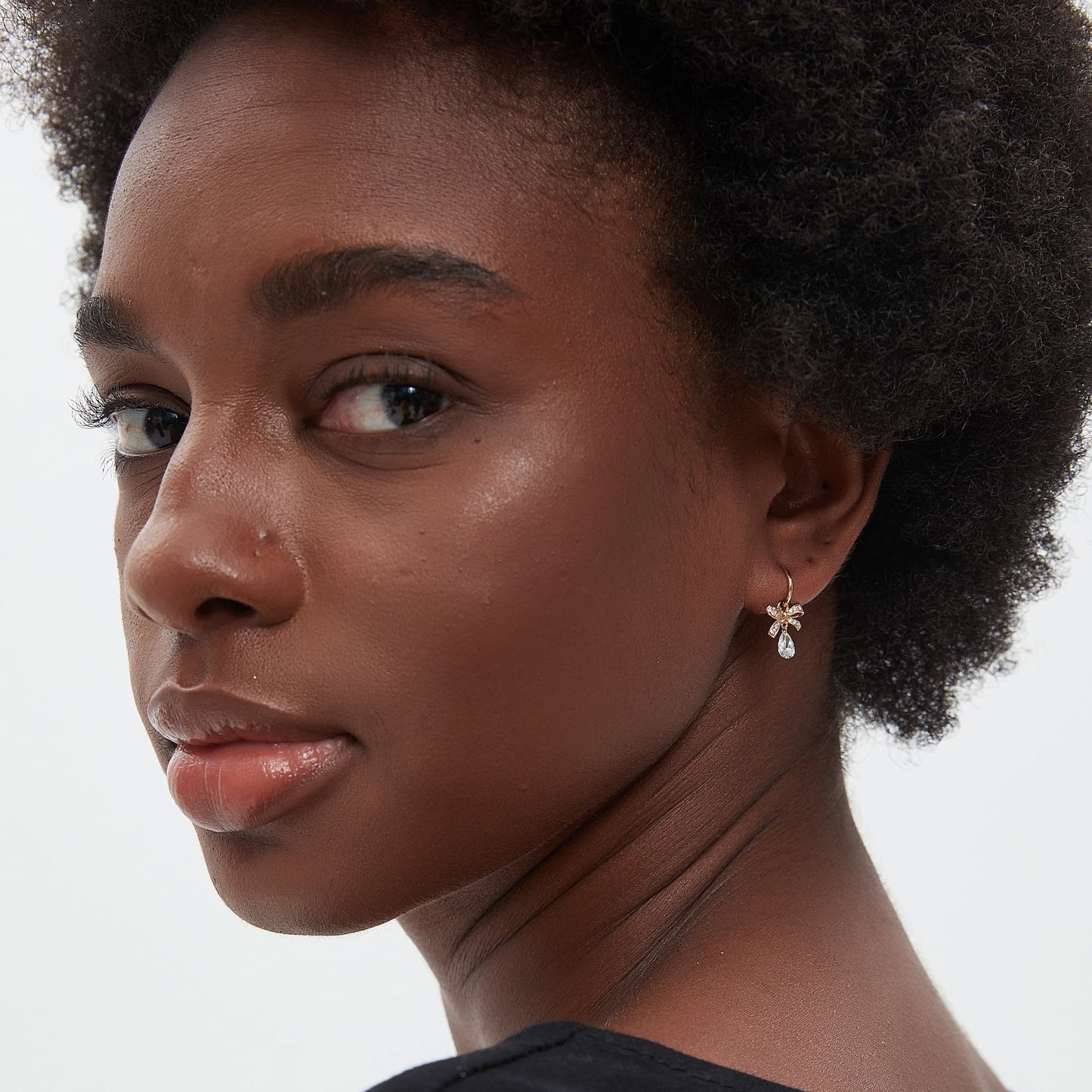 Model wearing butterfly bow pear drop diamond earring charm