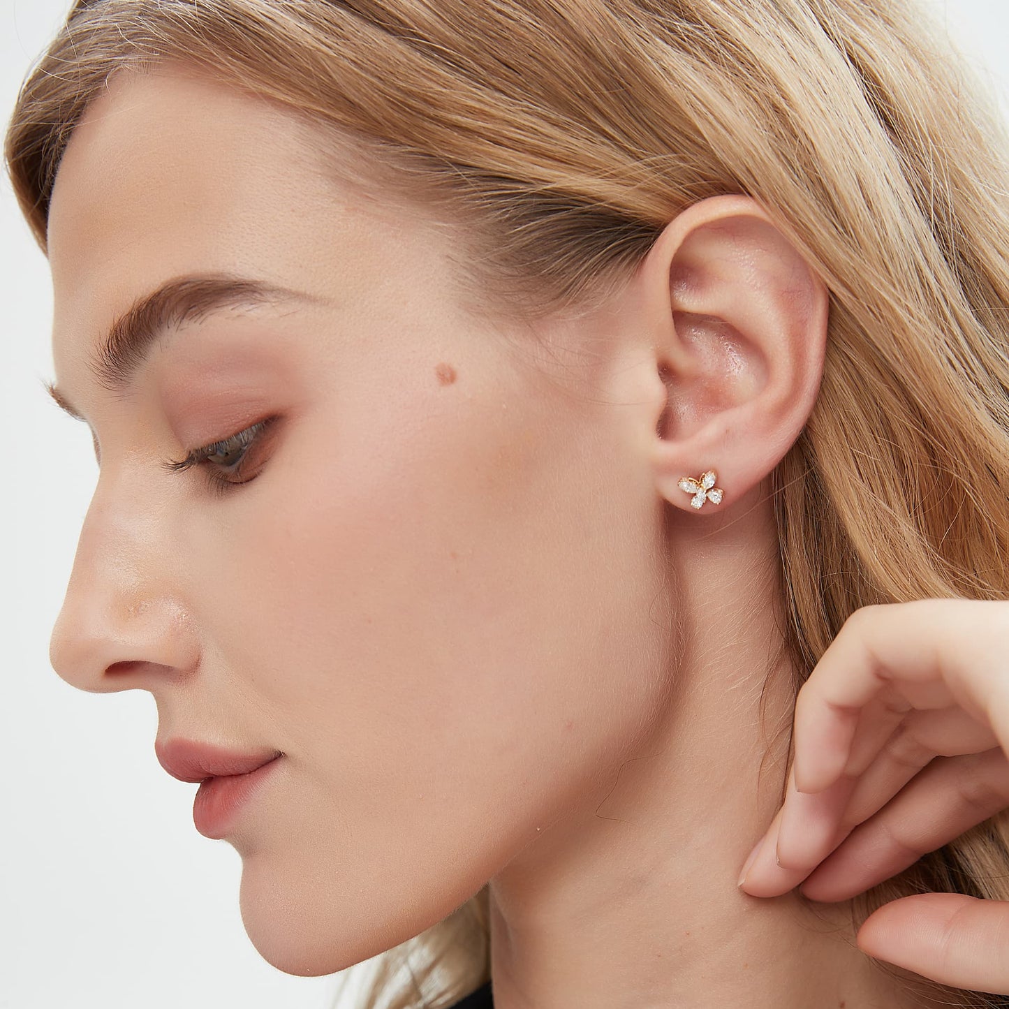 Side view of the butterfly diamond stud showing the solid 18K gold post