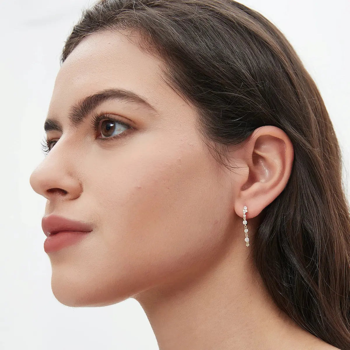 Side profile of the Radiant Cascade diamond dangle hoop, focusing on the secure hinged clicker mechanism and the sturdy 18K solid gold construction. The perspective shows the depth of the diamond cluster and the way the floating chain drapes naturally for a "liquid light" effect. This image highlights the smooth finish designed for comfort and side sleepers, confirming the professional piercing-grade quality of this LTM Jewels signature design for long-term wear.