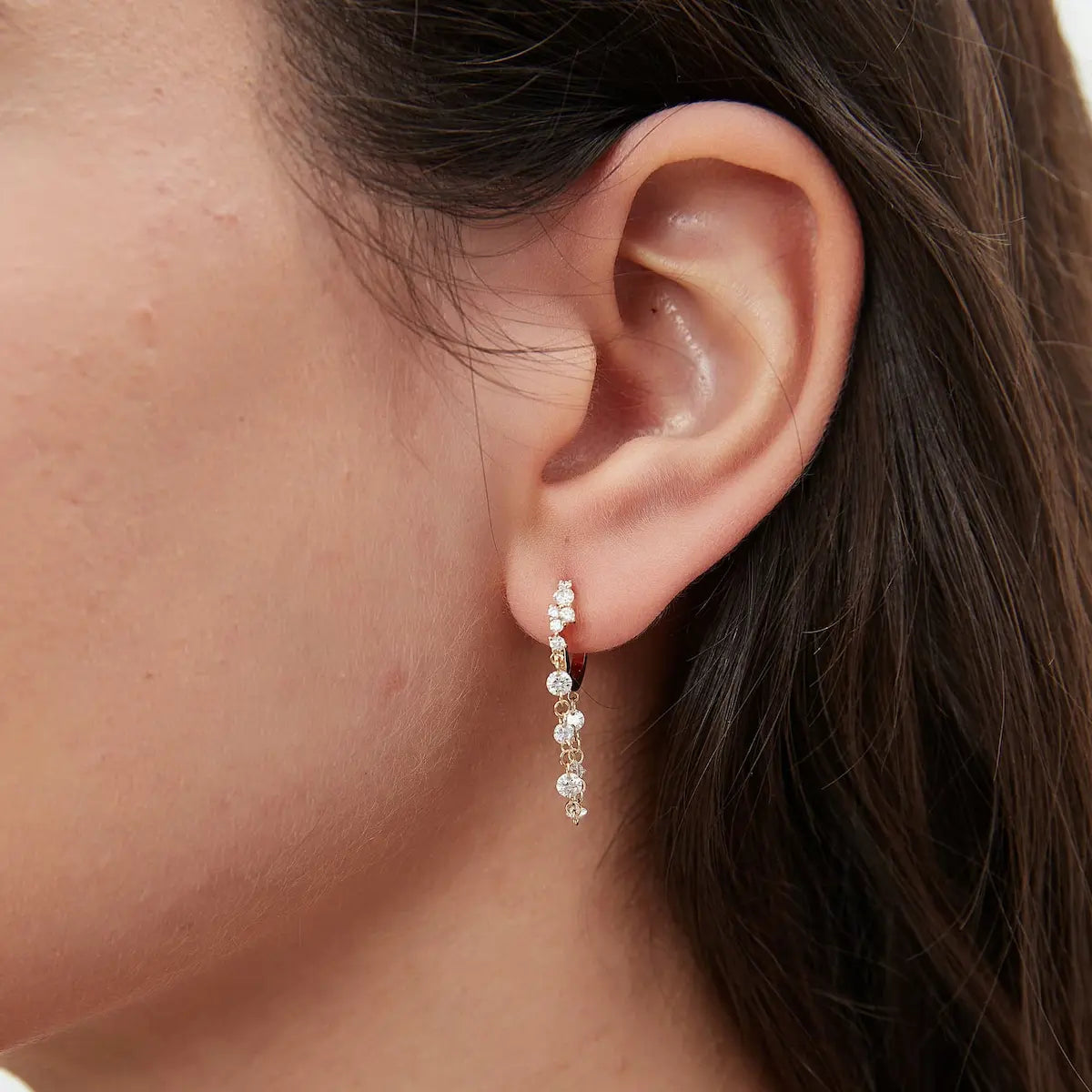 Detailed macro view of the 18K solid gold diamond cluster setting and the floating diamond chain, highlighting the intricate craftsmanship of the waterfall effect. The image captures the precision of the 0.11ct cluster on the 8mm hoop and the individual 0.08ct and 0.05ct diamonds along the fluid chain. Showcase of the exceptional fire and brilliance of LTM Jewels' premium lab-grown diamonds, demonstrating VVS clarity and the seamless, setting-free aesthetic of the dangles.