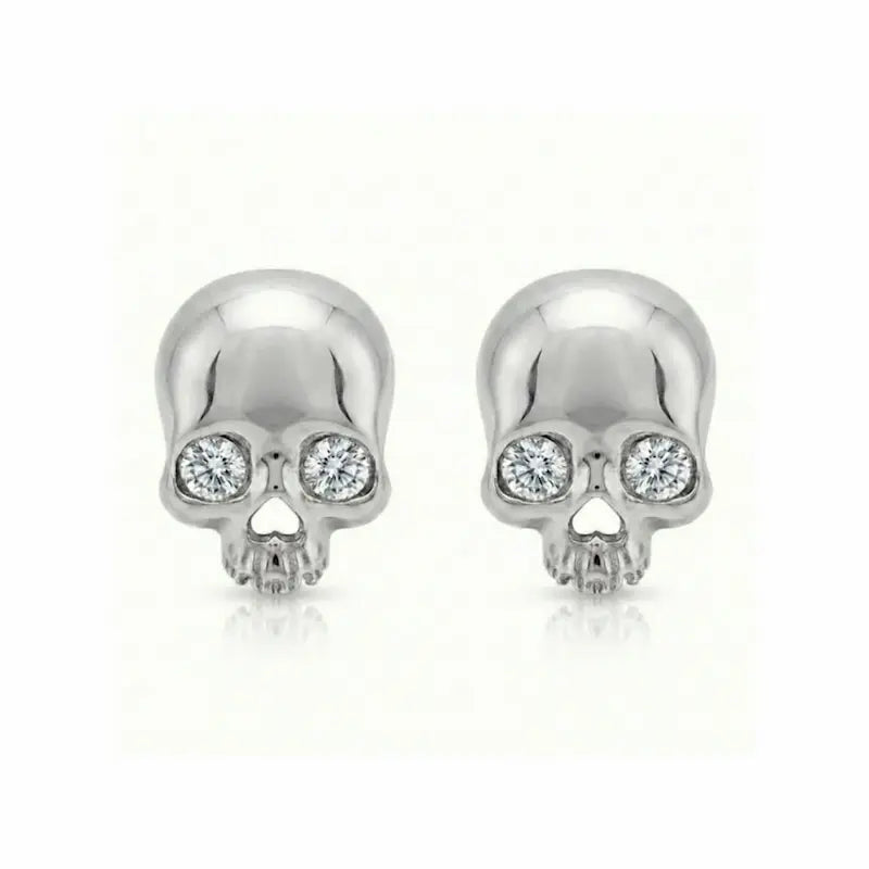 Memento-Mori-Main	A professional high-resolution studio photograph of the Diamond Skull Threaded Stud from the LTM Jewels Memento Mori collection. This 18K solid gold stud is meticulously sculpted with anatomical skull details and accented by a 0.02ct natural round brilliant diamond of VS1 clarity and E color. The image showcases the high-polish AU750 gold finish and the secure threaded screw back design against a clean background, highlighting the blend of rebellion and refinement.