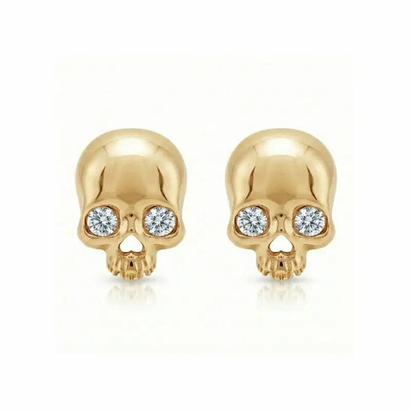 Memento-Mori-Main	A professional high-resolution studio photograph of the Diamond Skull Threaded Stud from the LTM Jewels Memento Mori collection. This 18K solid gold stud is meticulously sculpted with anatomical skull details and accented by a 0.02ct natural round brilliant diamond of VS1 clarity and E color. The image showcases the high-polish AU750 gold finish and the secure threaded screw back design against a clean background, highlighting the blend of rebellion and refinement.