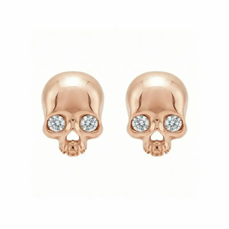 Memento-Mori-Main	A professional high-resolution studio photograph of the Diamond Skull Threaded Stud from the LTM Jewels Memento Mori collection. This 18K solid gold stud is meticulously sculpted with anatomical skull details and accented by a 0.02ct natural round brilliant diamond of VS1 clarity and E color. The image showcases the high-polish AU750 gold finish and the secure threaded screw back design against a clean background, highlighting the blend of rebellion and refinement.