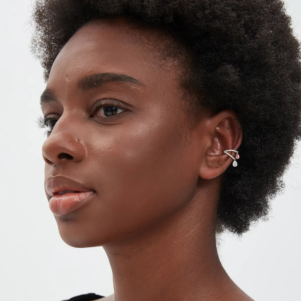 A technical side profile view of the Pink White Pear Pavé Dangle Ear Cuff. This image highlights the structural integrity of the 18K solid gold AU750 double-band construction and the secure slip-on fit for the ear cartilage. The profile view showcases the fluid motion of the dangling pear diamonds and the slim, comfortable profile of the pavé setting. The consistent high-polish finish and the alignment of the 0.6ctw diamonds are clearly visible, emphasizing the technical quality of this modular piece.