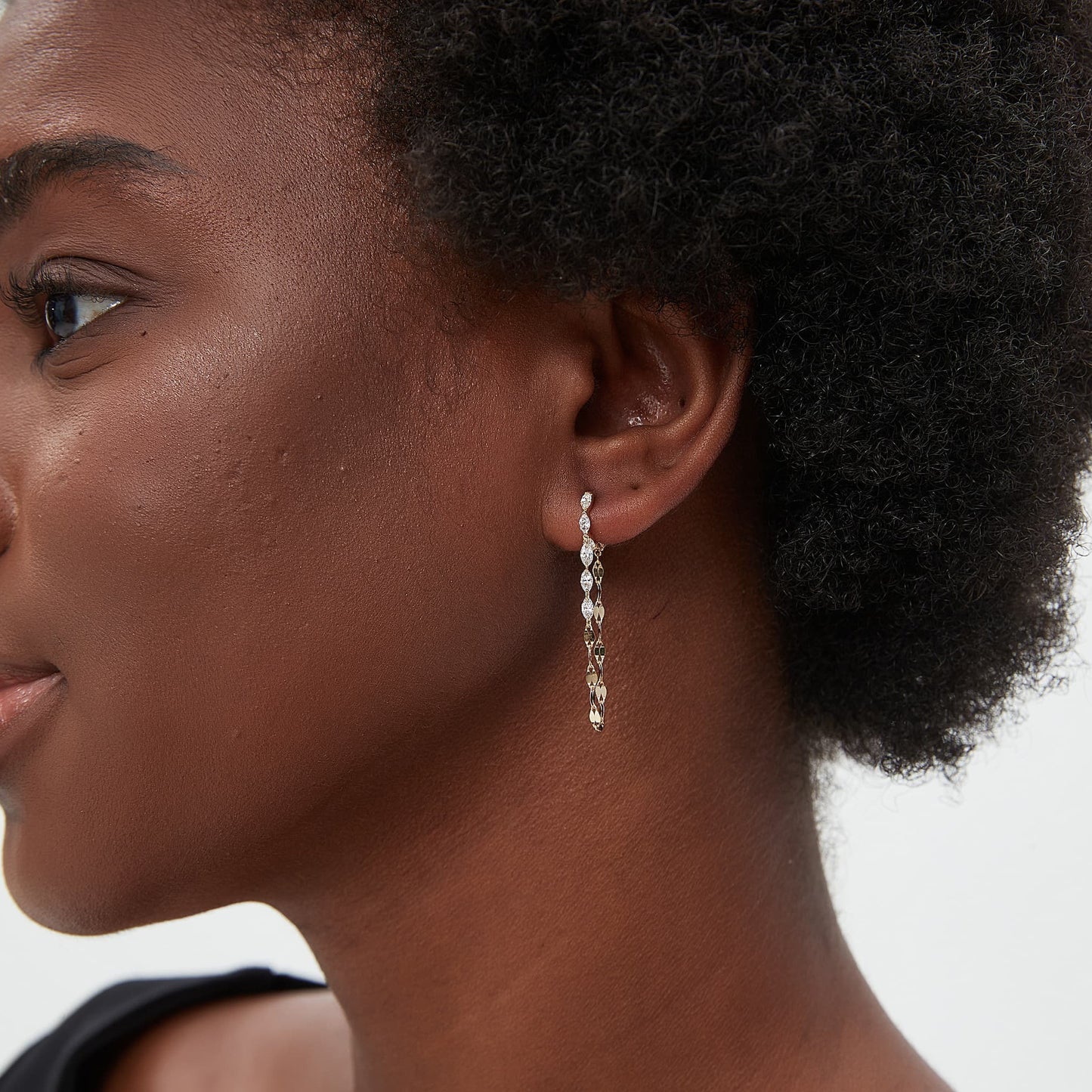 Model wearing The Geometric Sway marquise chain drop hoop in a luxury 18K gold ear stack