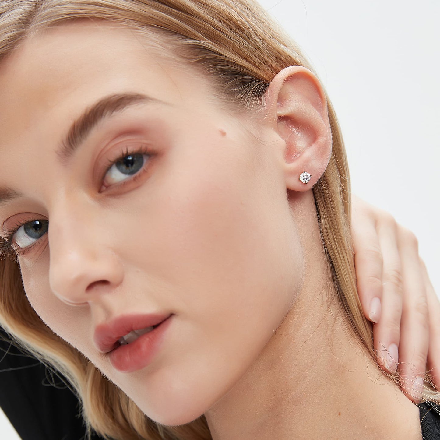 on ear of heart-prong setting round diamond stud earring in 18K gold