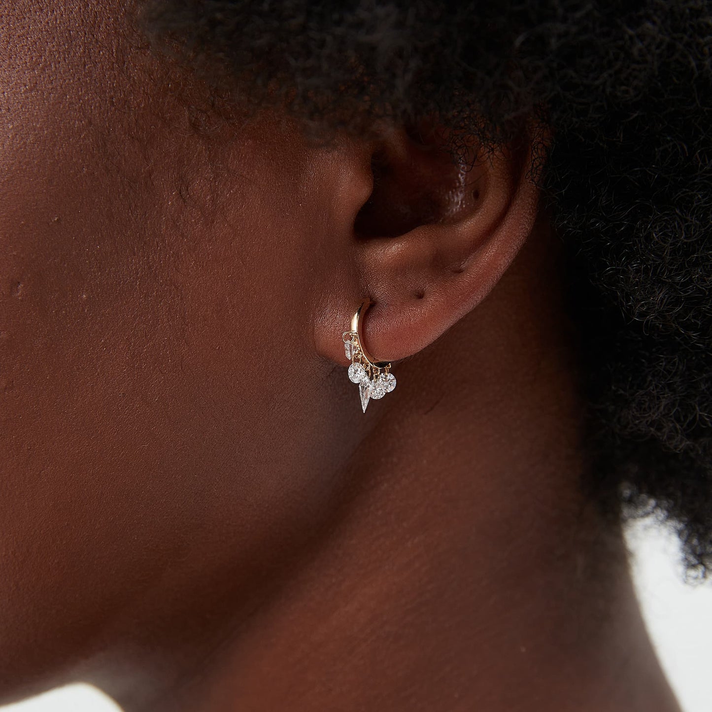 Side profile of 18K gold hoop showing the kite diamond and diamond chain movement