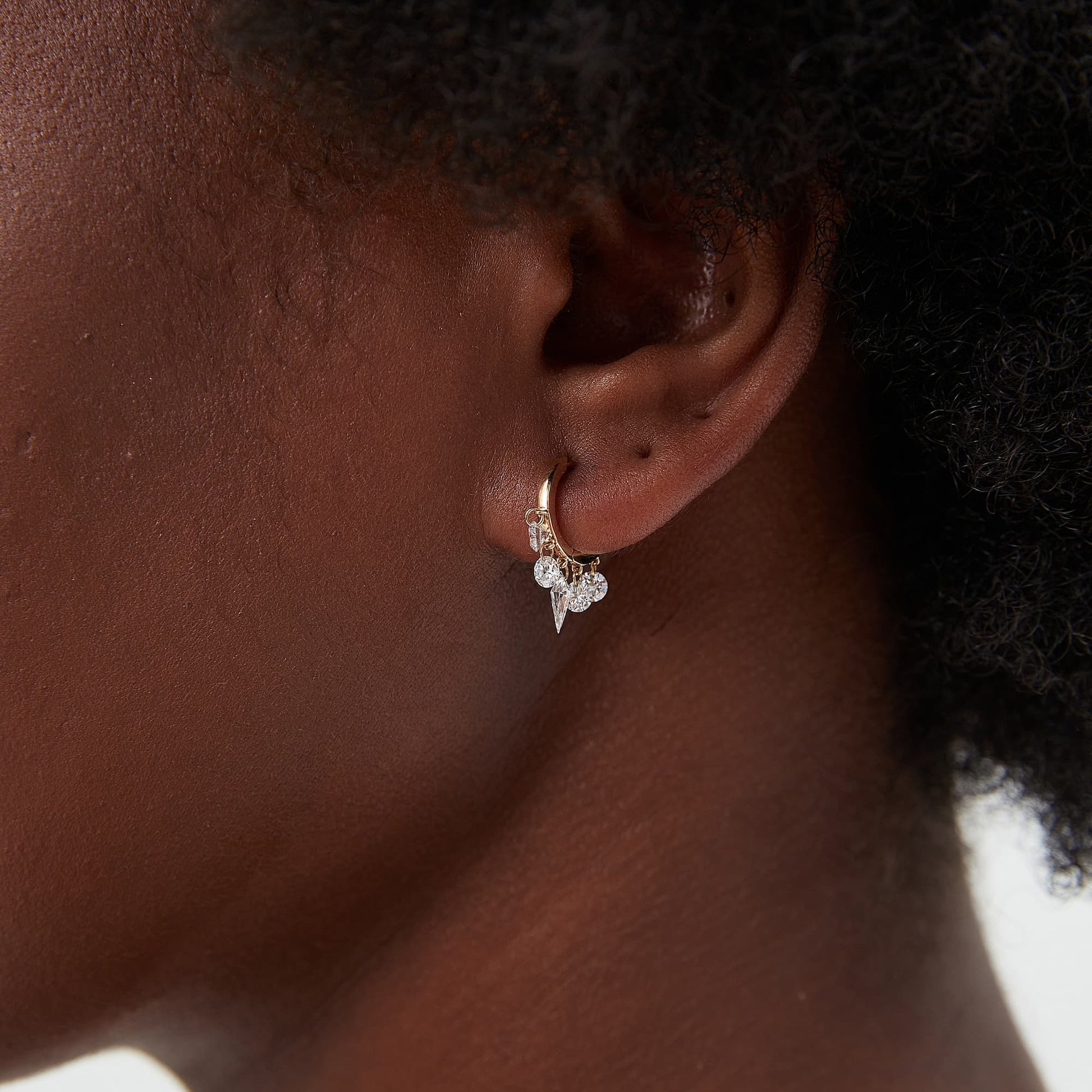 Side profile of 18K gold hoop showing the kite diamond and diamond chain movement