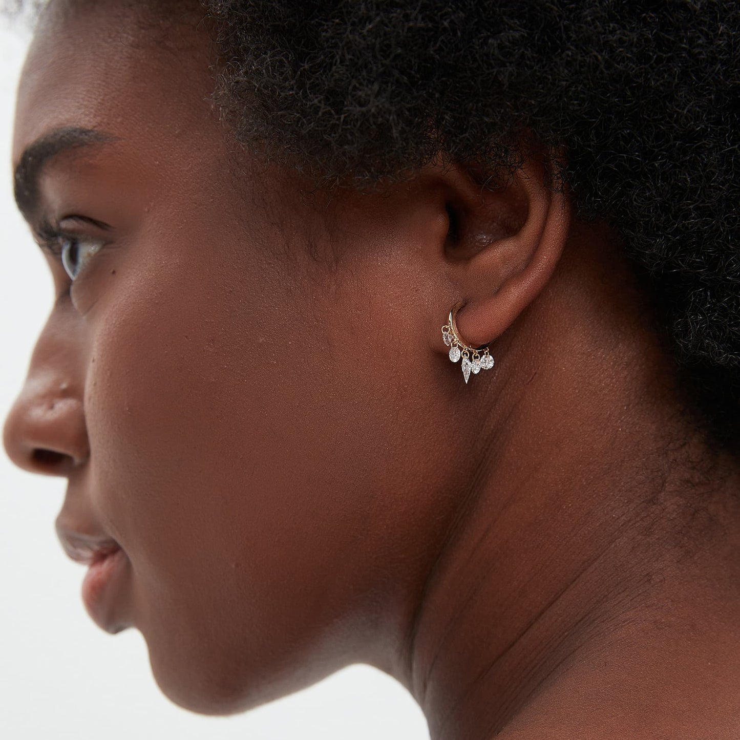 Curated ear stack featuring the Celestial Drift kite diamond chain dangle hoop