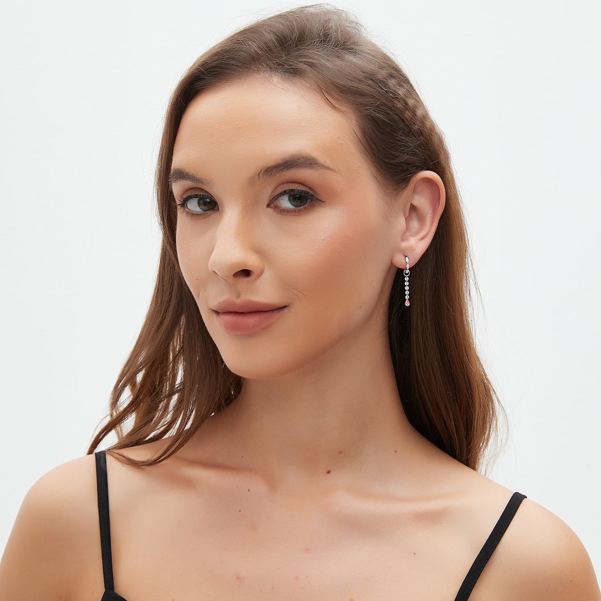 Luxury model showcasing the pink pear diamond charm in a curated 18K gold ear stack