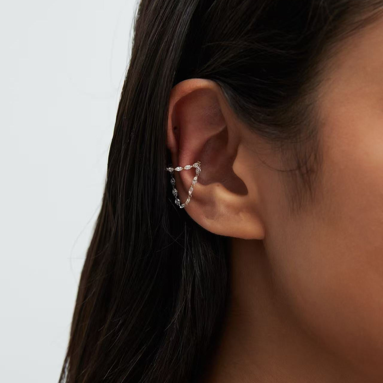 Close-up of VVS marquise lab grown diamonds on an 18K gold cascade cuff