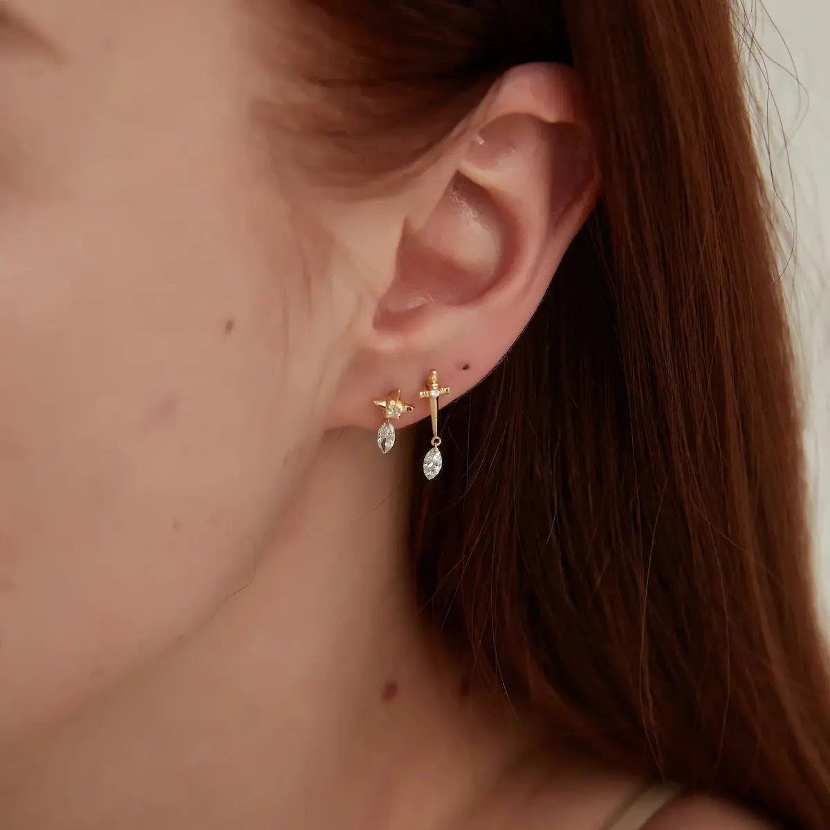 Macro detail of the LTM & CO.™ star stud and marquise dangle. Showcases the precise laser-drilling through the lab diamond, allowing it to hang directly from the 18K solid gold star. Highlights the brilliant facets of the marquise cut and the high-polish finish of the Au750 gold, emphasizing architectural precision and craftsmanship.