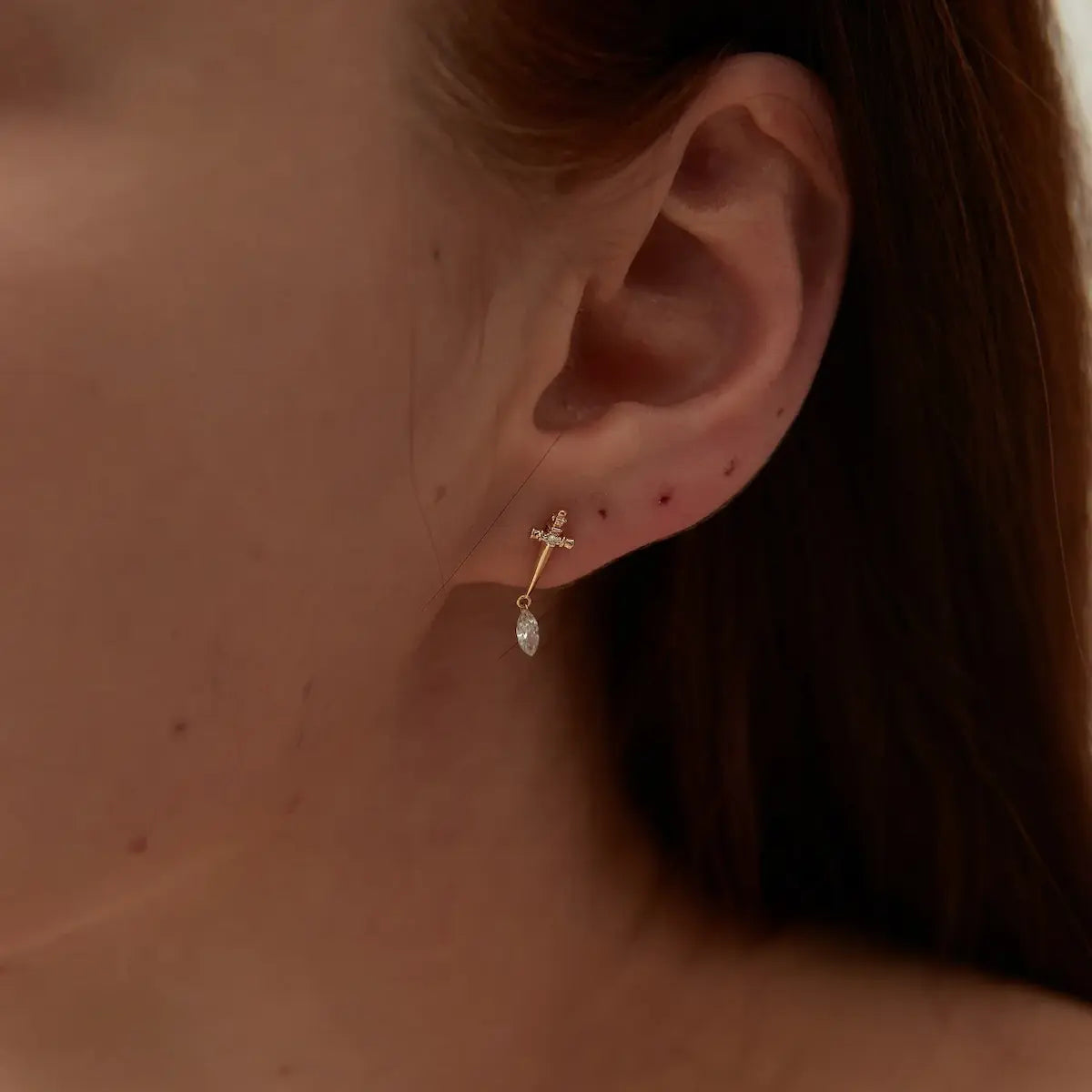 Close-up of Sword Marquise Dangle Threaded Stud in 18K gold, highlighting marquise diamond and precise setting