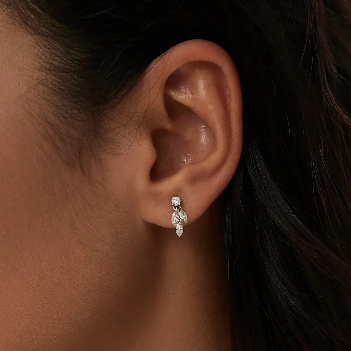 Close-up of Marquise Triple Dangle Threaded Stud in 18K gold, highlighting round diamond accent, cascading marquise diamonds, and precise dangle setting.