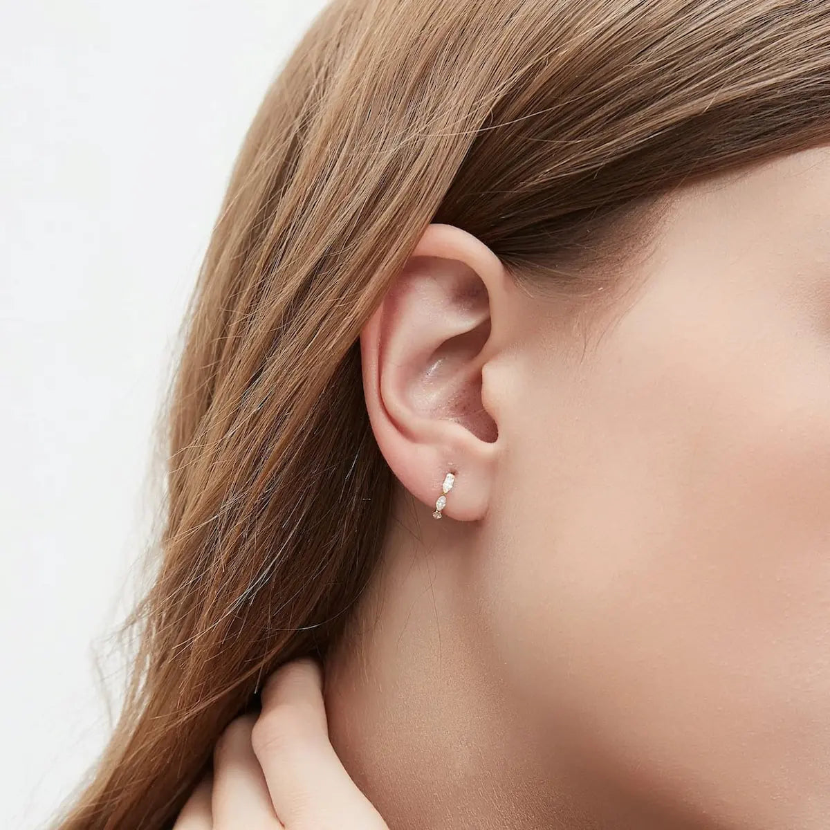 Side profile view of the 18K gold Marquise Row Hoop, focusing on the slim, comfortable profile and the sturdy clicker closure system. This perspective highlights the "click-to-lock" safety feature, ensuring the earring remains secure during sleep or active lifestyles. Designed for permanent wear, the side view confirms the shower-safe and tarnish-free nature of LTM Jewels' solid gold construction, offering professional piercing-grade quality for a lifetime.