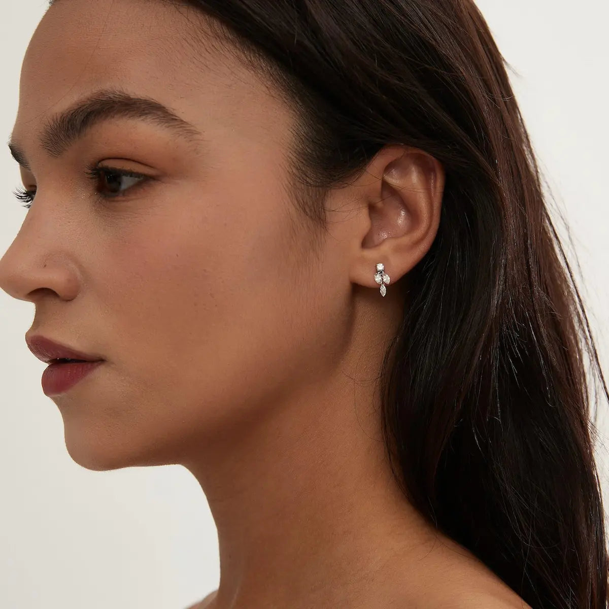 Marquise Triple Dangle Threaded Stud worn on ear in 18K solid gold, showcasing round diamond top and three marquise diamond drops for elegant movement.
