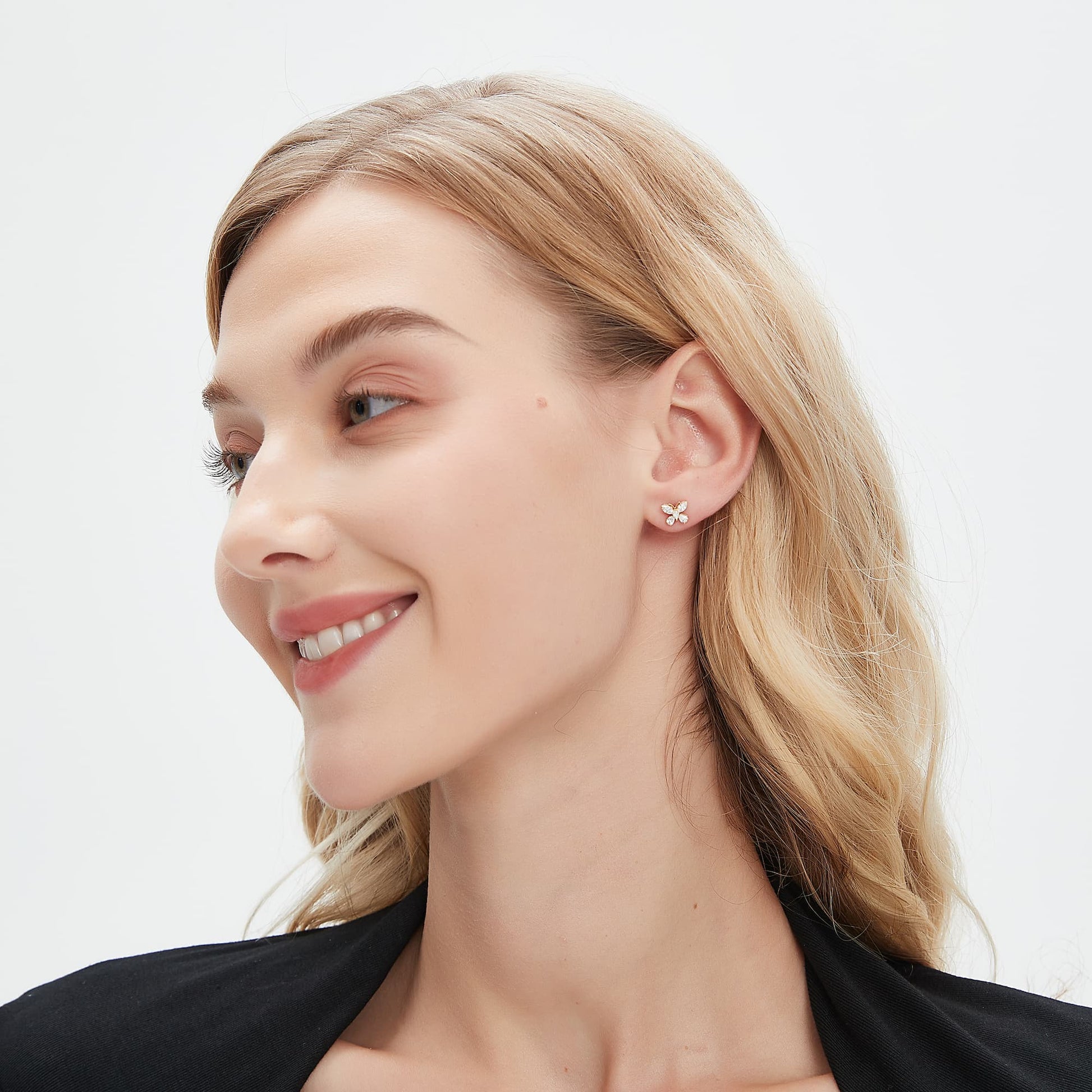 Model wearing the Whimsical Flight butterfly diamond stud on the ear lobe