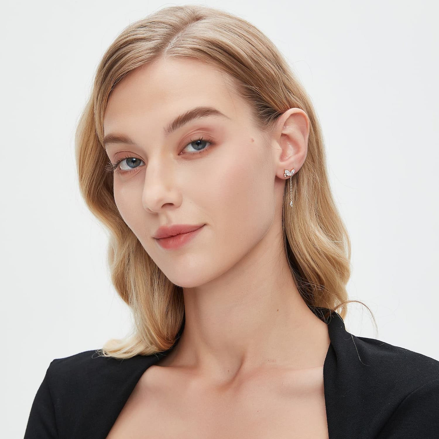 A fashion editorial shot featuring the Pear Butterfly Dangle Stud. Captures the piece as a modern heirloom in flight, showcasing its role as a sophisticated statement of nature-inspired luxury within a high-fashion look.