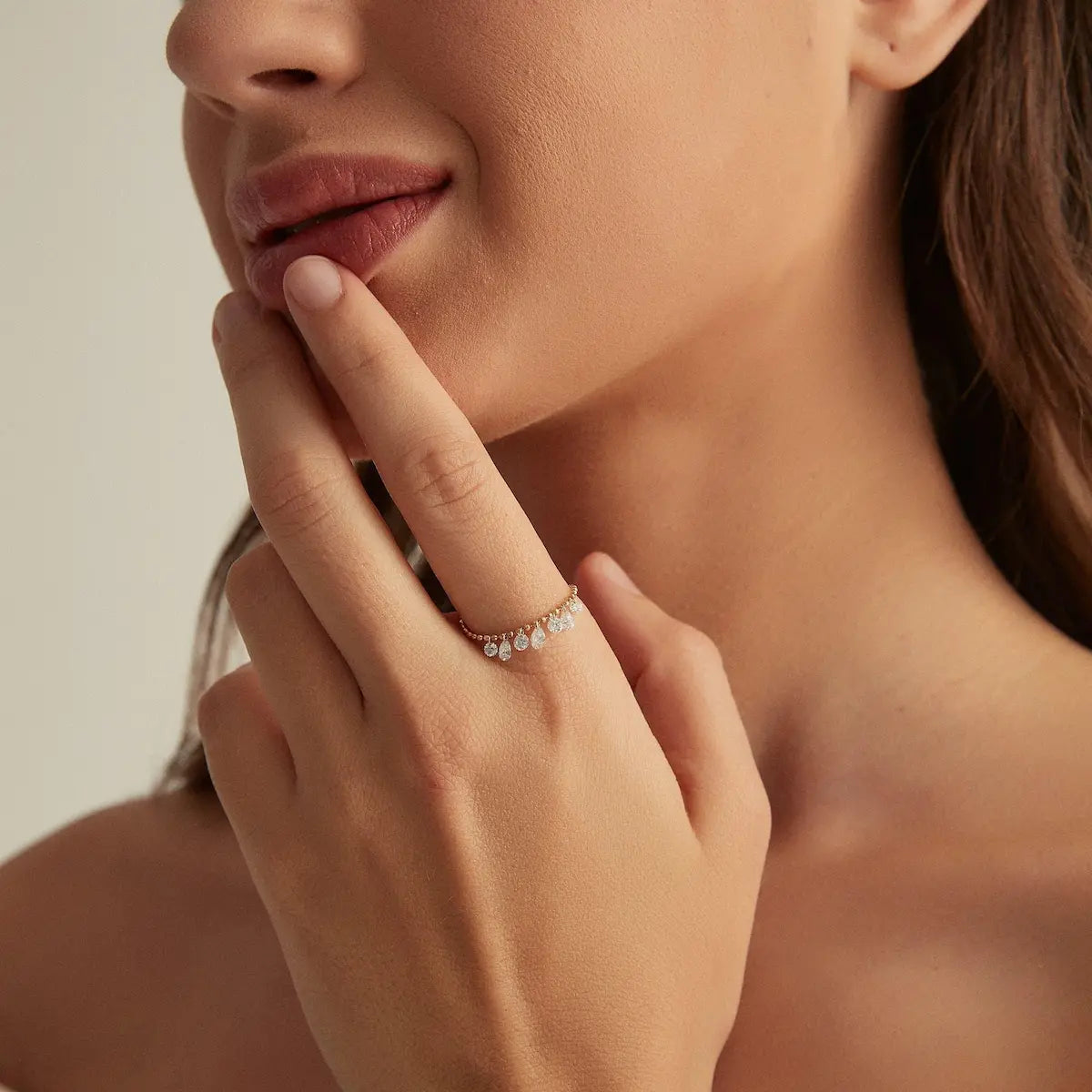 Model wearing the Seven Drilled Diamond Beaded Ring from the Radiant Drift collection. The suspended floating diamonds create rhythmic brilliance and fluid movement against the polished gold beaded band, offering a modern minimalist interpretation of luxury diamond ring styling.